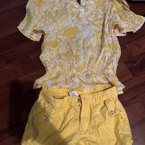 Yellow and White flower top. Top has flared out arm. Yellow bottom.